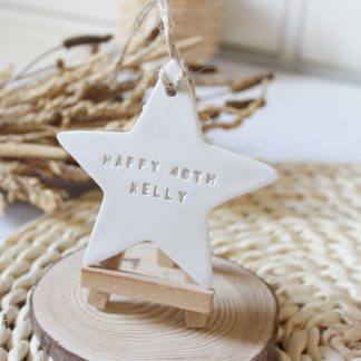 Personalised Happy Birthday star keepsake handmade from clay and customised with a name and age. A thoughtful birthday gift and lasting memory.